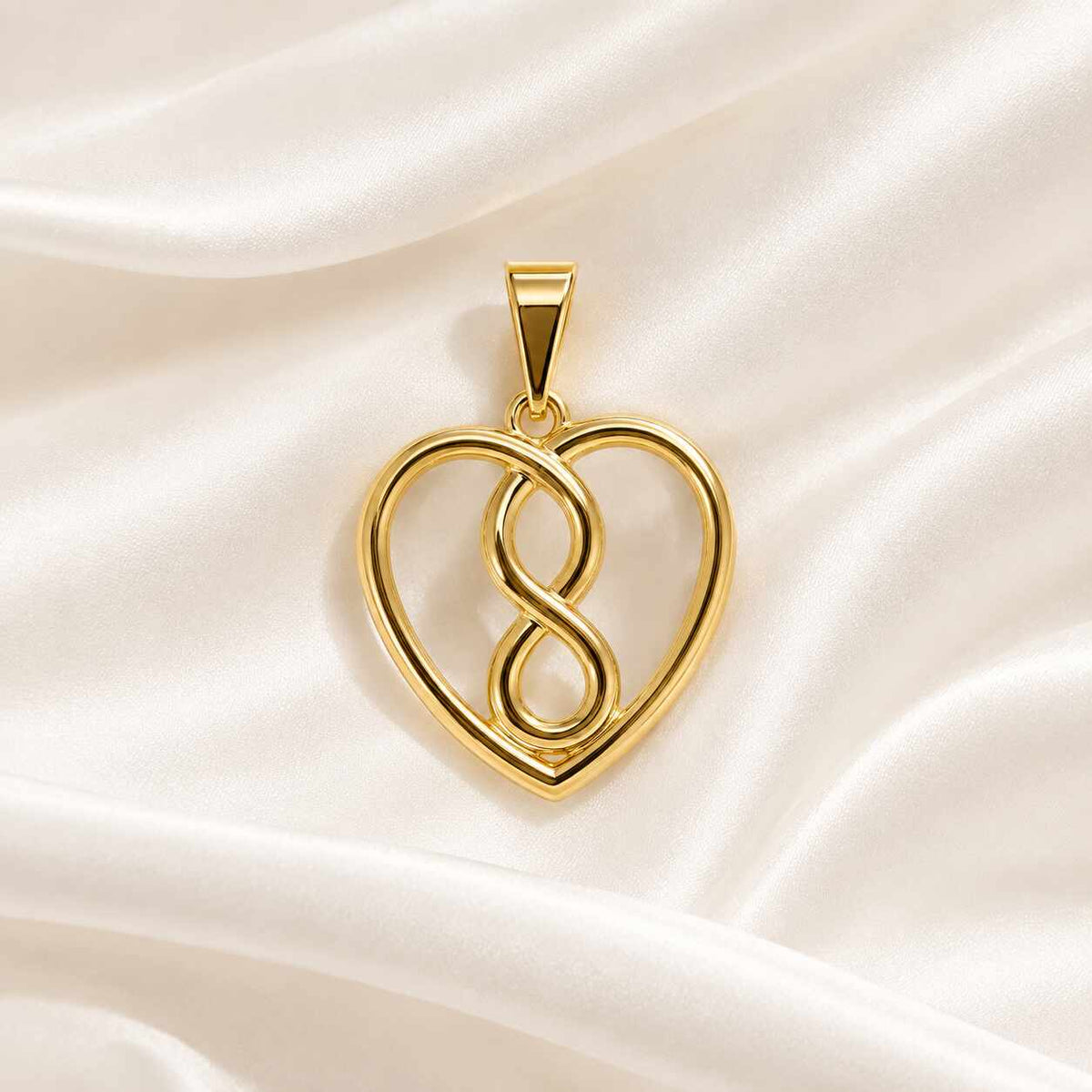 Dije liso en forma de corazón y infinito en oro