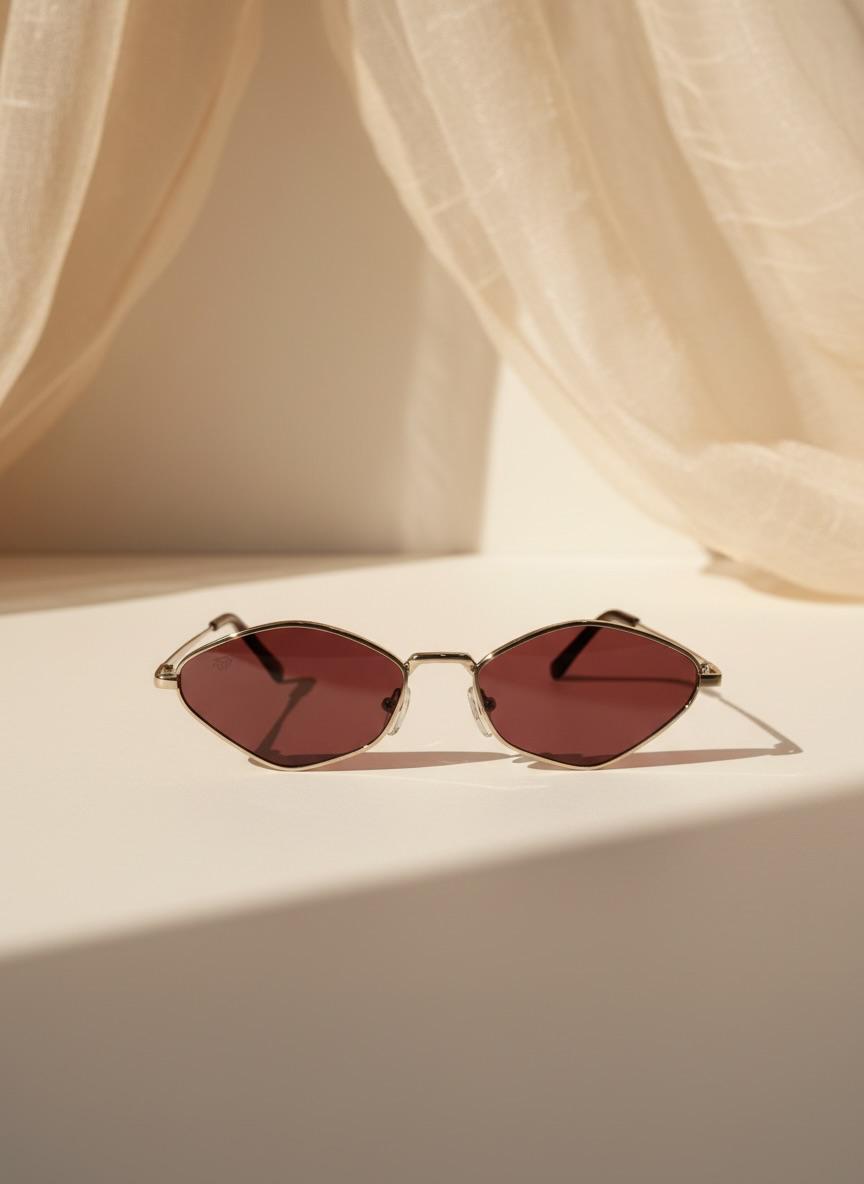 Su diseño fino y lentes en tono rojizo crean un look moderno y lleno de actitud. Perfecto para convertir un outfit simple en uno inolvidable.