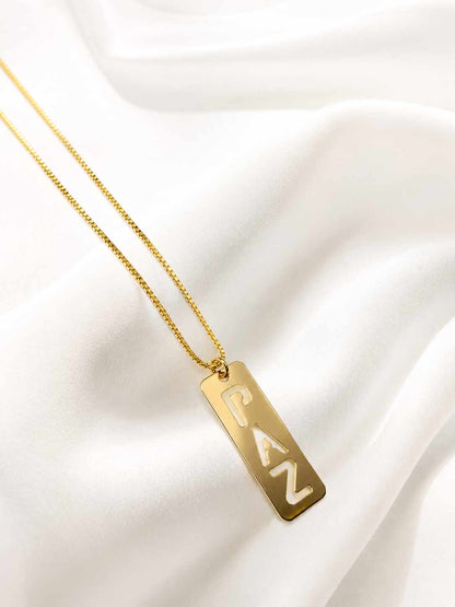 Collar con placa escrita con la palabra ¨paz¨, una pieza delicada y con mucho signficado.