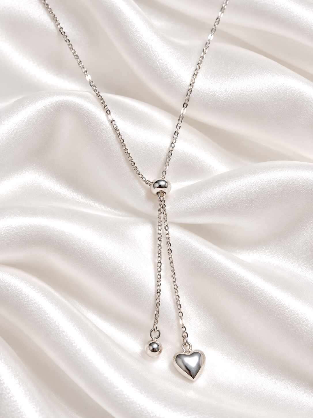Corbata esfera corazón baño plata 