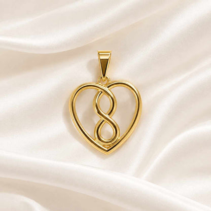 Dije liso en forma de corazón y infinito en oro